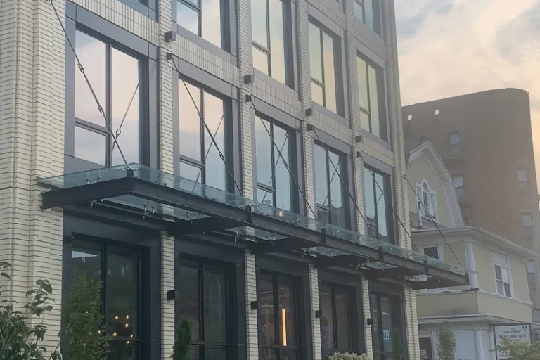 Suspended glass awning